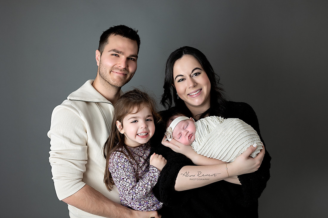 Chicago newborn photographer family session in Wheeling, IL, studio featuring parents and two sisters