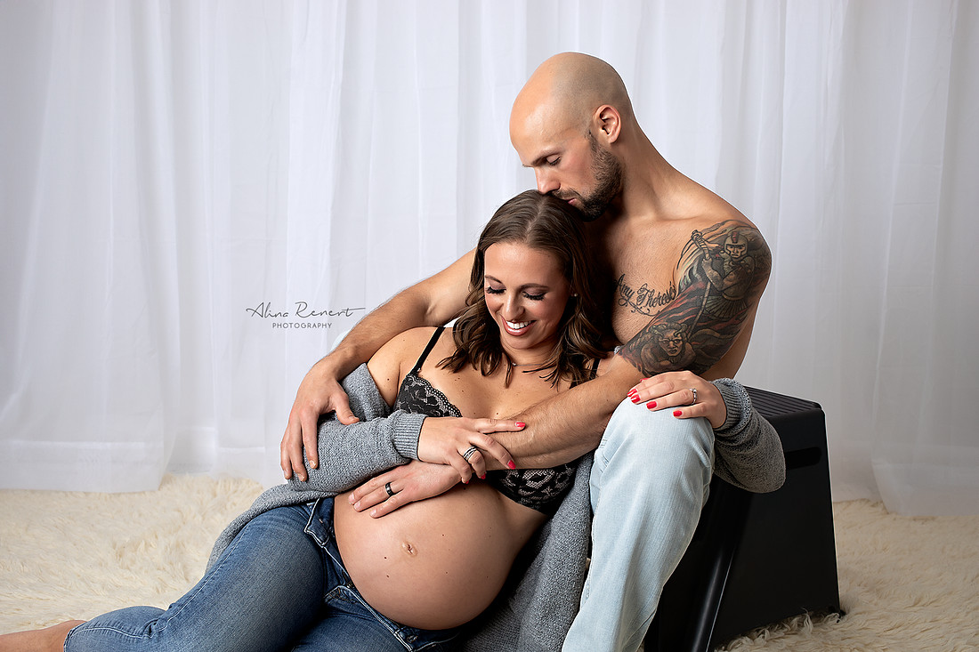 Modern maternity photography in Wheeling, Illinois focusing on the connection between parents and the baby bump.